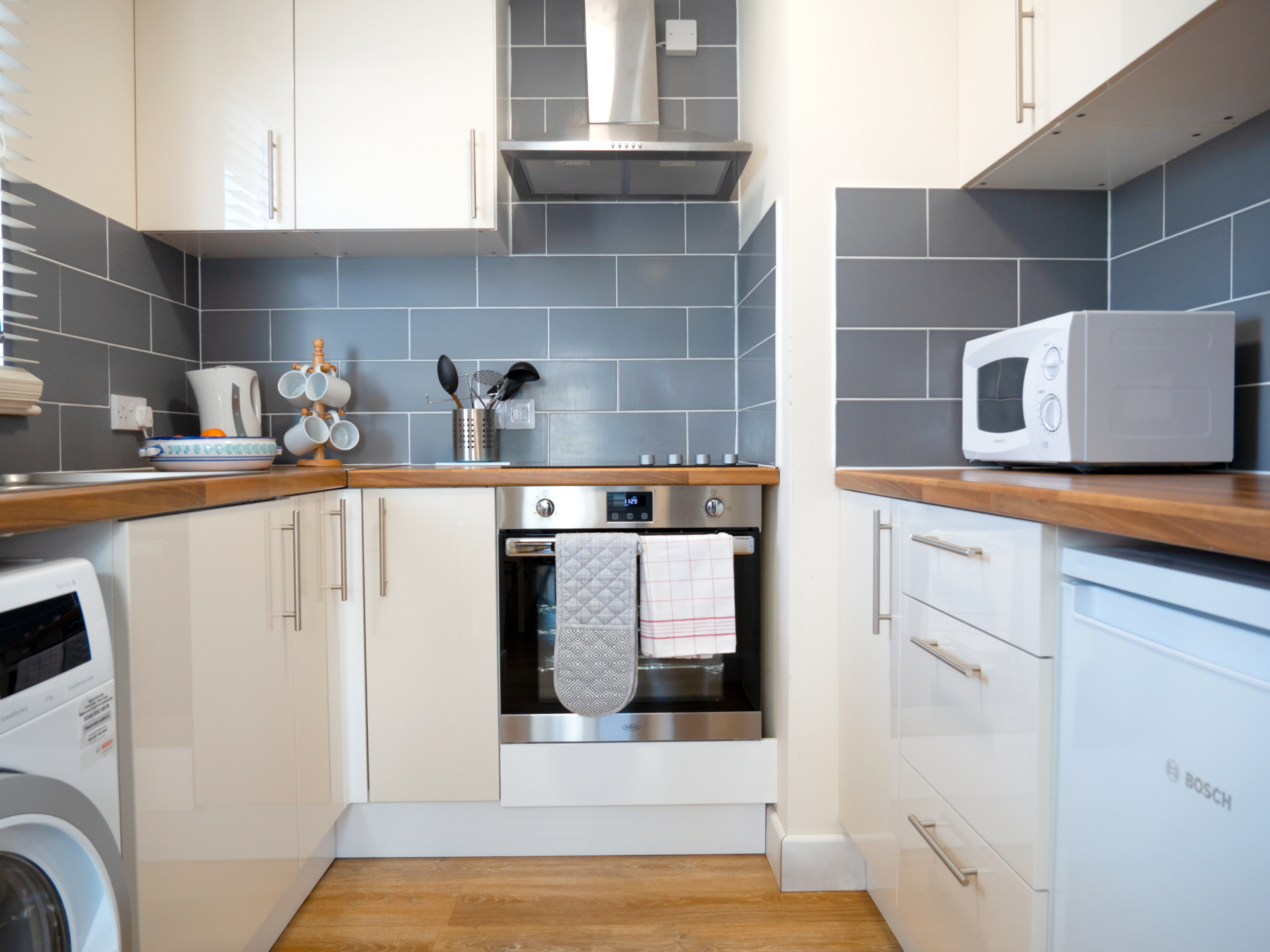 Fully-fitted kitchen has a washing machine and all the pots and pans and crockery that should be needed