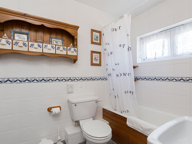 Ensuite bathroom with bath with shower over, basin and toilet