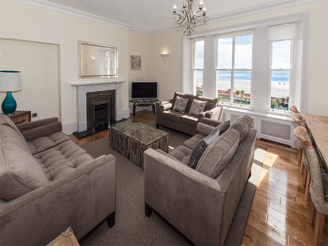 Open plan lounge and dining area with views of St Aubin