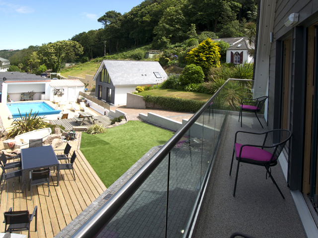 Balcony on first floor overlooks the garden and shared outdoor pool