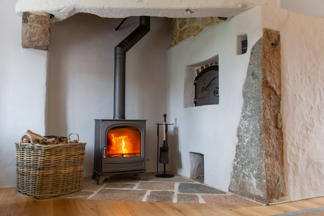 Bakehouse with its substantial bread oven (not in use) and working log burning stove