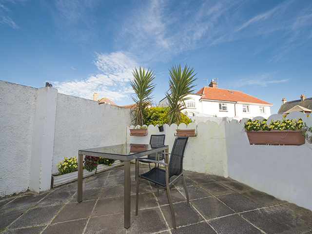 Patio with table and chairs outside the kitchen