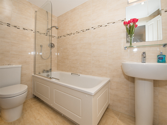 Ensuite bath room with bath with shower over