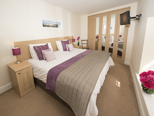 This large bedroom can accommodate another single bed and can also be made up as 3 singles