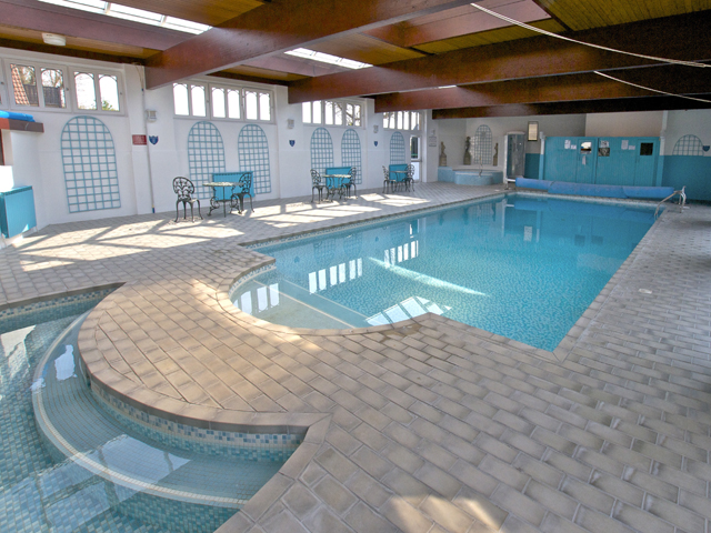 View of heated indoor pool at Beausite Apartments