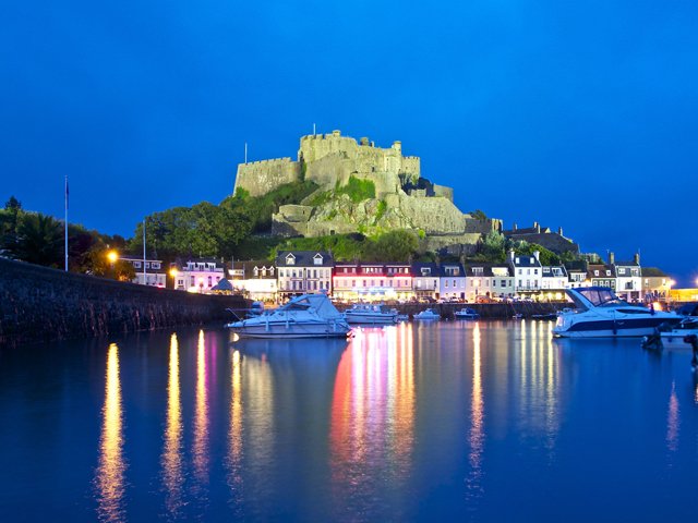 Night view of Mont Orgueil Castle just along the coast from Beausite Apartments
