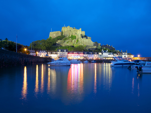 Night view of Mont Orgueil Castle just along the coast from Beausite Apartments