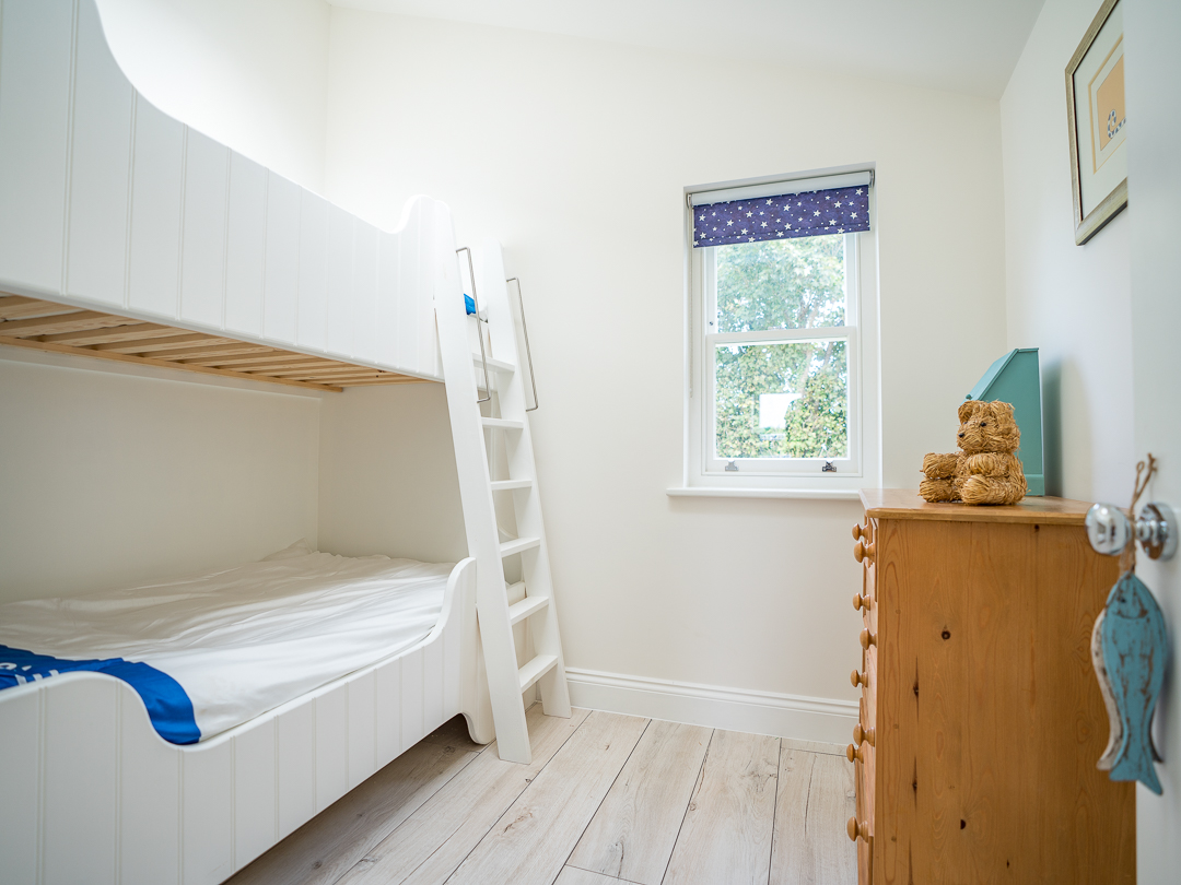 Second bedroom with large single bed plus single bunk bed above