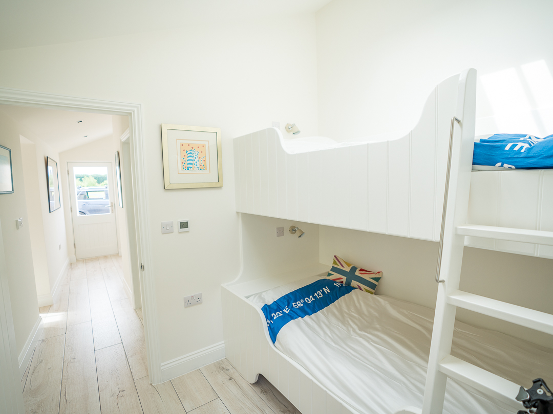 Second bedroom with hallway to bathroom and utility area