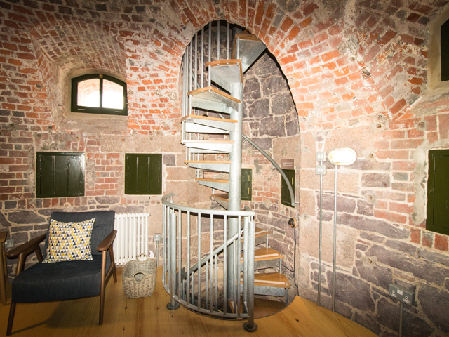 Narrow spiral staircase runs throughout 4 floors