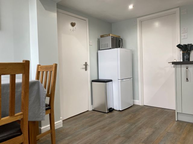 Bedroom/lounge door to the left and shower room to the right