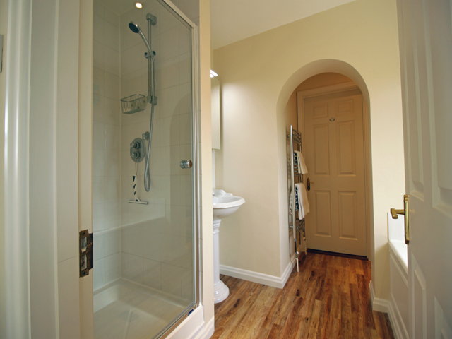 Bathroom with large shower cubicle and separate bath, basin and WC