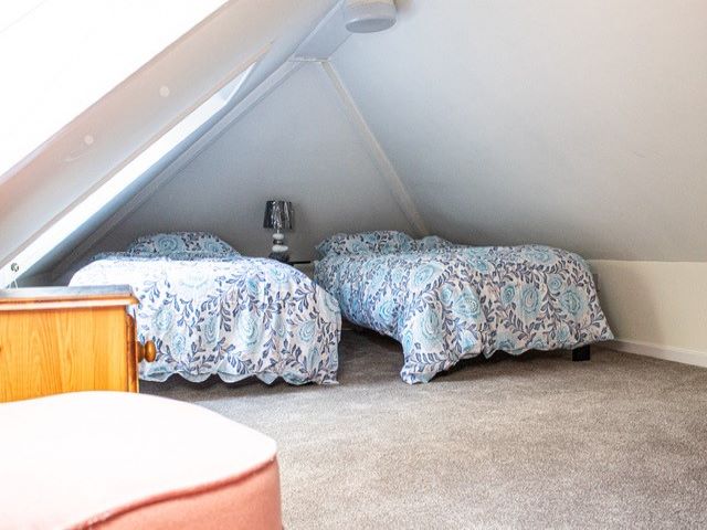 The second bedroom has single beds and would be ideal for children or teenagers due to the very low ceiling height